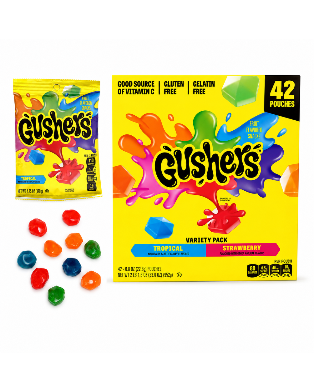 A box of Gushers Tropical and Strawberry flavor gelatin pouches shown on a white background, alongside a single pouch and several loose colorful gummy candies. The packaging is bright yellow with multicolored splash graphics and the Gushers logo.