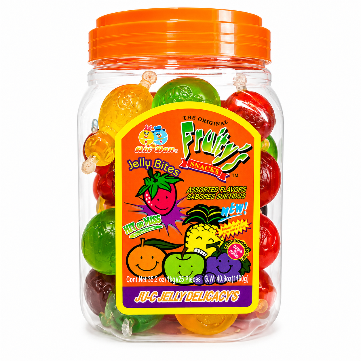 A clear plastic jar filled with assorted colorful jelly bites gummy candies, topped with a bright orange lid. The front features a large, colorful label for 'Juicy Misses' 'The Origin's Fruitiness Snacks'.